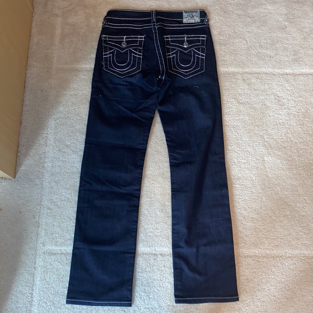 True religion wide and boot cut jeans with white border stitching.